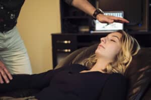 Young woman with hypnotherapist in session. Young woman with hypnotherapist in session.